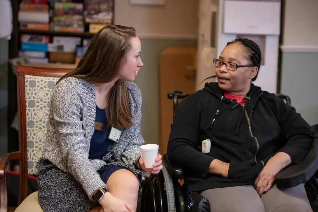 Student with AU GIVS visits with a resident of Good Shepherd nursing home